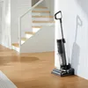 A wet and dry vacuum cleaner is shown standing next to a wall with vertical stripes, near a staircase. Náhled obrázku produktu