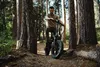 A man is riding an electric bicycle in a forest. Produktbild-Vorschau