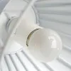 A close-up view of a light bulb inside a white fixture. Produktbild-Vorschau