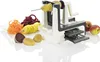 A spiralizer with various vegetables and fruits, including potatoes, carrots, and beets, arranged around it. Produktbild-Vorschau