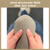 A close-up view of a person's hands holding a sock, demonstrating a feature of the sock. Produktbild-Vorschau