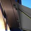 A close-up view of a modern awning system attached to a building, showing mounting brackets and the fabric. Produktbild-Vorschau