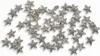 A scattering of small, glittery star-shaped confetti pieces on a white background. Produktbild-Vorschau