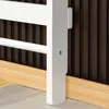 A close-up view of the bottom corner of a white wooden climbing frame, showing its leg and horizontal bars, against a dark ribbed background and a light wooden skirting board. Voir les images du produit