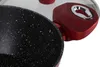 A close-up view of a speckled black pot with a red handle and lid. Podgląd zdjęcia produktu