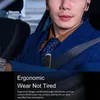 A man wearing a suit and tie in a car, with a Bluetooth headset. Produktbild-Vorschau