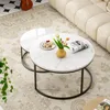 A set of nesting coffee tables with marble-like tops and black metal frames, placed on a rug in a living room setting. Voir les images du produit