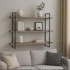 A three-tiered wooden shelf with decorative items mounted on a wall above a sofa. Náhľad obrázku produktu