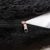 Close-up of a black fluffy pillow with a silver zipper. Produktbild-Vorschau