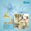 A product image featuring a blue toy gramophone with a yellow horn, surrounded by decorative blue flowers and a box displaying product information. Náhľad obrázku produktu