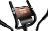 Close-up of the console and handlebars of an elliptical trainer, with a tablet displaying a media player interface. Produktbild-Vorschau
