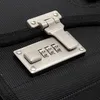 A close-up of a combination lock on a black fabric surface. Produktbild-Vorschau
