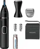 A collection of personal grooming tools and accessories, including a nose trimmer, various attachments, a battery, and a storage pouch, arranged on a white background. Podgląd zdjęcia produktu