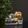 A festive Christmas village scene with a house, snowman, and children, illuminated by LED lights. Podgląd zdjęcia produktu