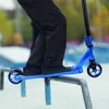 A person is performing a trick on a scooter in a skate park. Náhľad obrázku produktu
