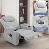 A light gray recliner chair with a footrest extended, placed in a living room setting with a bookshelf in the background. Náhľad obrázku produktu