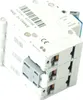 A close-up, angled view of three stacked electrical circuit breakers. Produktbild-Vorschau