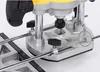 A close-up view of a wood router base with a dust collection attachment. Náhled obrázku produktu