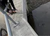 A person is using a cordless drill near a body of water. Náhled obrázku produktu