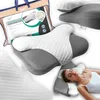 A collage of images showcasing an orthopedic memory foam pillow, including a person sleeping on it and its packaging. Náhled obrázku produktu