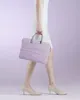 A person is holding a laptop bag. Náhľad obrázku produktu