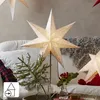 A festive indoor scene with illuminated paper stars, a couch, and decorative elements. Produktbild-Vorschau