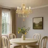 A dining room with a table, chairs, and a chandelier. Anteprima dell’immagine prodotto