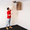 A man is using a long-handled brush to clean an attic hatch. Produktbild-Vorschau