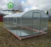 A polycarbonat greenhouse is set up in an outdoor grassy area with a cloudy sky in the background. Produktbild-Vorschau