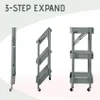 A three-step expansion process of a gray rolling cart is shown against a white and light gray background. Voir les images du produit