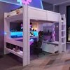 A loft bed with a desk and gaming setup underneath, illuminated by LED lights. Produktbild-Vorschau