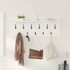 A white wall-mounted coat rack with a shelf above it, displaying various items like scarves, bags, keys, and umbrellas. Voir les images du produit