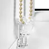 A close-up of a clear plastic bracket holding a beige beaded cord for a window blind. Produktbild-Vorschau