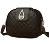 A black quilted handbag with a gold clasp is shown against a white background. Náhled obrázku produktu