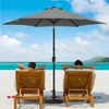 Two people relaxing on lounge chairs on a beach under a gray umbrella. Produktbild-Vorschau