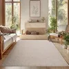 A living room scene with a sofa, rug, and fireplace. Podgląd zdjęcia produktu