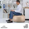 A man is sitting on a gym ball in an office setting, working on a laptop. Produktbild-Vorschau