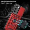 A red and black phone case with a ring holder is shown attached to a car vent mount. Produktbild-Vorschau