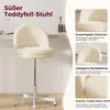 A cream-colored teddy fur chair with a white base and wheels, shown in a room with a desk and bottles in the background. The image also includes close-up shots highlighting the chair's features. Náhled obrázku produktu