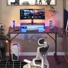 A gaming desk setup with a monitor, keyboard, mouse, and chair, illuminated by LED lights. Anteprima dell’immagine prodotto