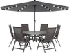 A dark gray patio umbrella with LED lights and a matching table and chairs set. Produktbild-Vorschau