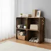 A wooden crate shelving unit filled with towels, books, and shoes, decorated with string lights. Náhled obrázku produktu