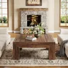 A living room scene with a fireplace, two sofas, and a coffee table. Voir les images du produit