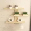 Three wooden shelves mounted on a tiled wall, decorated with small potted plants and decorative whale figurines. Produktbild-Vorschau