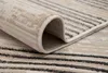 A close-up view of a rolled-up rug with a striped pattern. Voir les images du produit