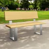 A park scene with people sitting on benches and enjoying the outdoors, with a focus on a modern wooden and metal bench in the foreground. Produktbild-Vorschau
