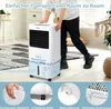A person is moving a portable air cooler in a room. Produktbild-Vorschau