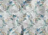 A seamless pattern of watercolor floral elements, featuring white blossoms and blue and green leaves, on a textured off-white background. Produktbild-Vorschau