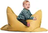 A baby sitting on a yellow beanbag chair.