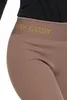 A close-up view of the waistband of brown leggings with the text 'STAY COSY' printed on it. Produktbild-Vorschau